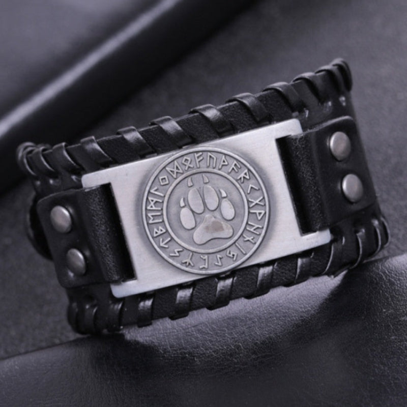Zoom sur la plaque en acier du bracelet avec empreinte de loup entourée de runes nordiques, ajoutant une touche mystique et tribale.