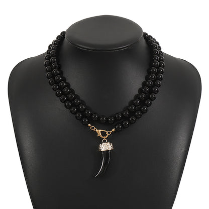 "Collier dent de loup pour femme avec pendentif noir élégant, parfait pour un style mystérieux et captivant."

